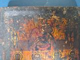 an old wooden box with a painting of a group of people on it