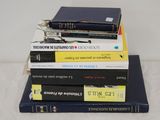 books stacked on top of each other on a white surface