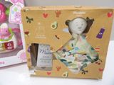 a box with a doll in it and a baby doll in it