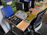 a desk with a computer and many books on it
