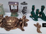 a table with a lot of items on it including vases, candles, and figurines