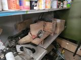 many boxes and tools on a shelf in a room