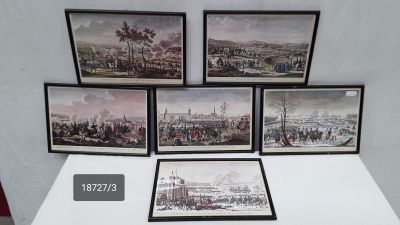 four framed pictures of a view of a city with a clock on a table