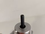 a close up of a metal object on a table with a box in the background
