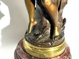 a statue of a woman holding a baby on a marble base