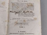 an old book opened to show the title of a poem