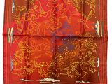 a close up of a red and orange handkerchief on a white background