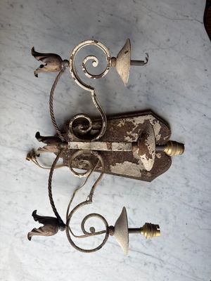 a metal object on a table with a lamp on it