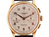 a close up of a gold wrist watch with a brown leather strap