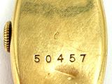 an image of a close up of a gold watch on a white surface