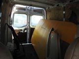 a surfboard in the back of a van with the door open