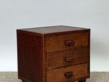 an image of a small chest of drawers on a carpet