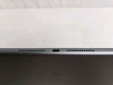the back of a laptop computer sitting on top of a white table
