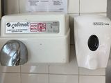 a paper towel dispenser and a paper towel dispenser on the wall