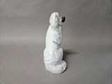 statue of a white dog with a chain around its neck