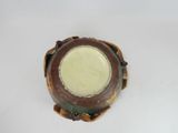 a brown and white bowl with a yellow center