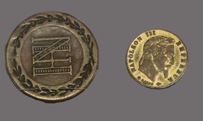 a close up of a coin and a coin on a gray surface