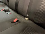 a close up of a car seat with a cell phone in it