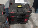 two black and red boxes sitting next to each other on the floor