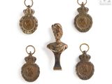 four bronze medals and a bust of a woman