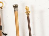 four different types of canes are lined up against a white wall