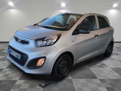a silver small car parked in a room with a checkered floor