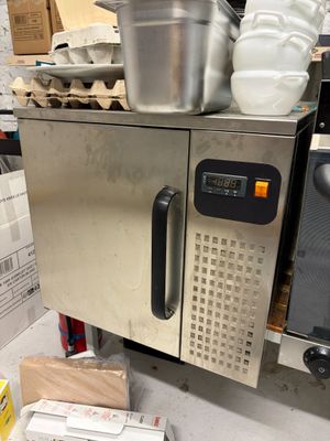 an image of a kitchen with a microwave and a pot on top of it
