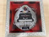framed picture of a cd in a red frame with a black and white logo