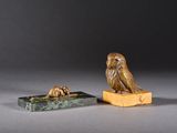 an image of a statue of an owl sitting on top of a box