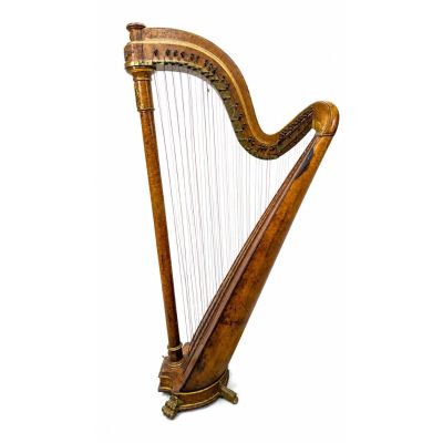 a large wooden harp sitting on top of a white surface