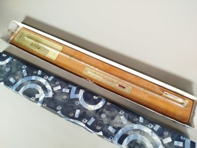 deux stylos et un crayon dans une boîte posée sur une table