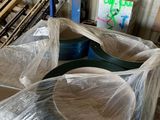 a lot of plastic wrapped furniture in a warehouse