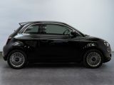 the small black car is parked on the concrete floor in the room