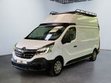 the white van is parked inside of a building with a roof rack