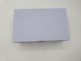 a close up of a blue box on a white surface