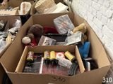 a box full of stuff sitting on the floor next to a brick wall
