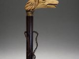 an old cane with a wooden head and chain around it