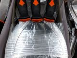 four pairs of black and orange shoes in a box