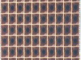 a close up of a brown and black plaid fabric with circles on it