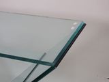 the glass top of a glass table with a metal base