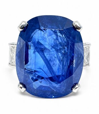 an oval blue sapphire ring set in white gold with diamonds