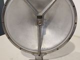 a silver metal object on a table with a white background