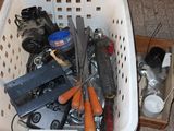 a basket full of assorted tools and tools on the floor