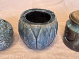 three vases sitting next to each other on a table