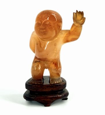 a small statue of a man on a wooden stand