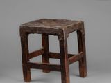 an old wooden stool with a wooden seat on a gray background