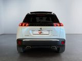 the rear end of a white suv parked in a white room