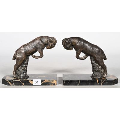 a pair of bronze sculptures of two dogs on marble bases