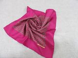a close up of a pink handkerchief on a white surface
