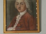portrait of a man in a red coat in a room